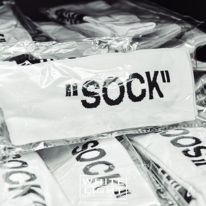 Pile of packaged socks with the word 