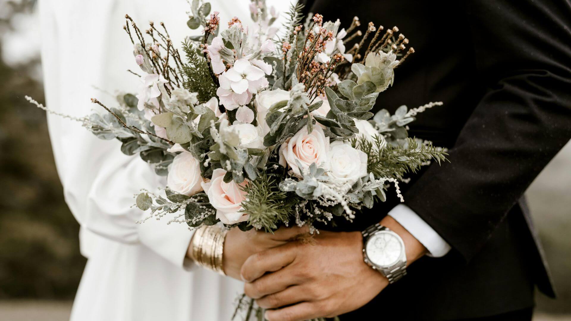 An intimate moment between a bride and groom that also shows a beautiful, upscale bouquet, perfect for a micro wedding.