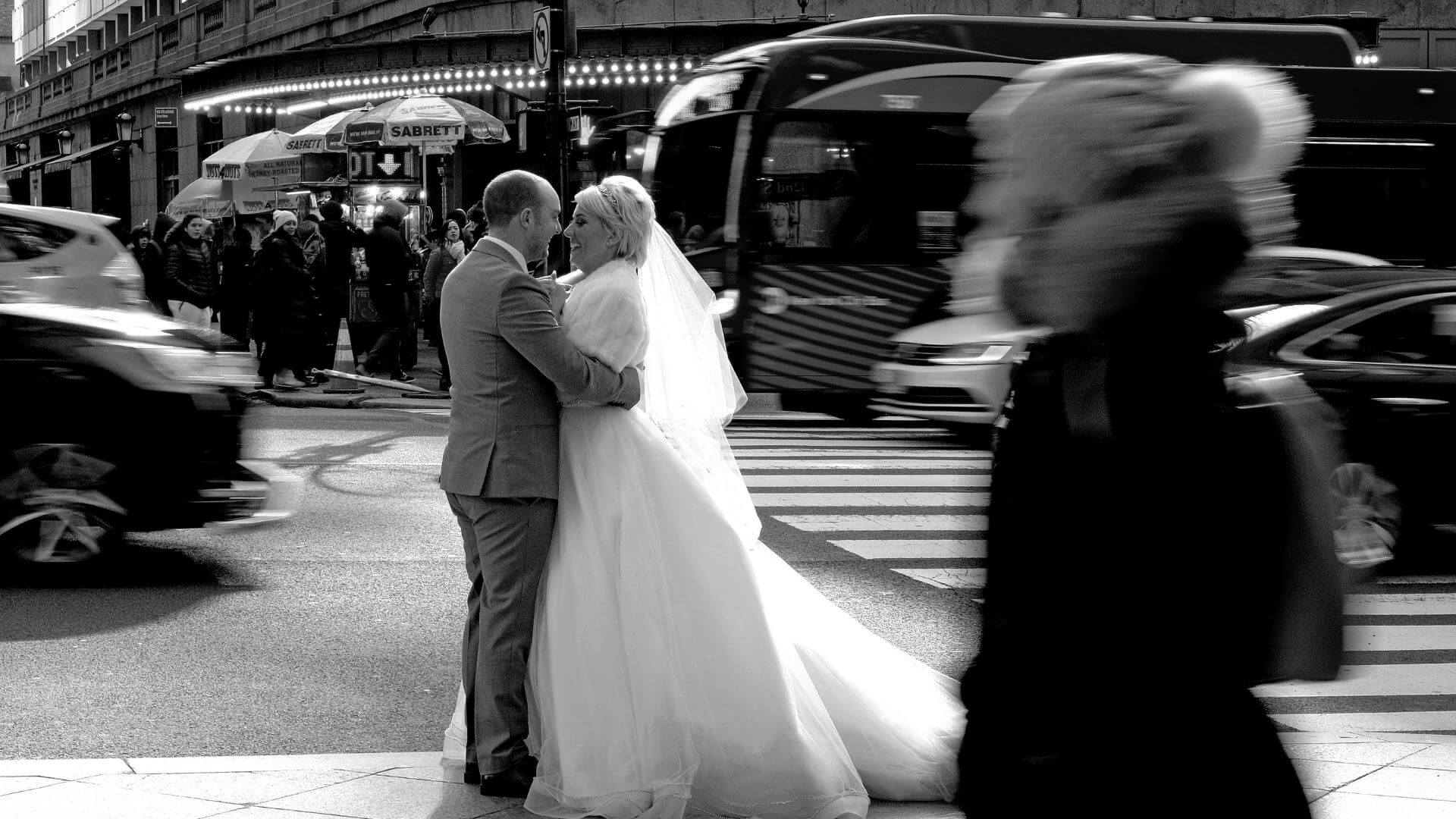 A recently married couple on the streets of New York City with the bride in her gown.