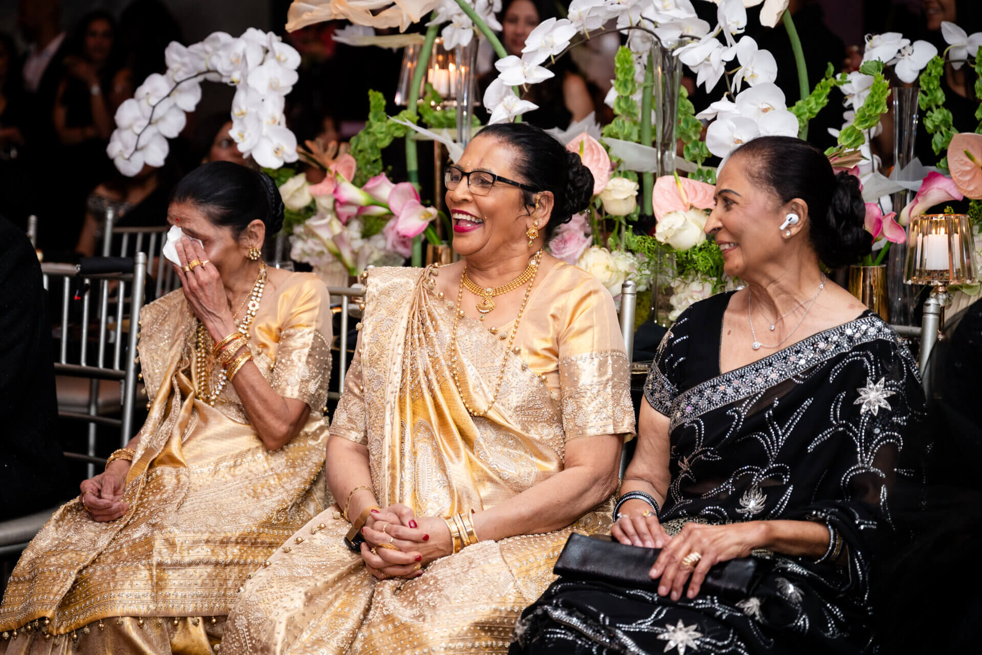 Family members sit at a Sweet 16 birthday party laughing.